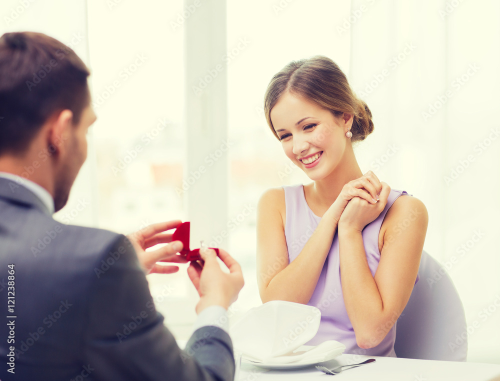 excited young woman looking at boyfriend with ring excited young woman looking at boyfriend with ring