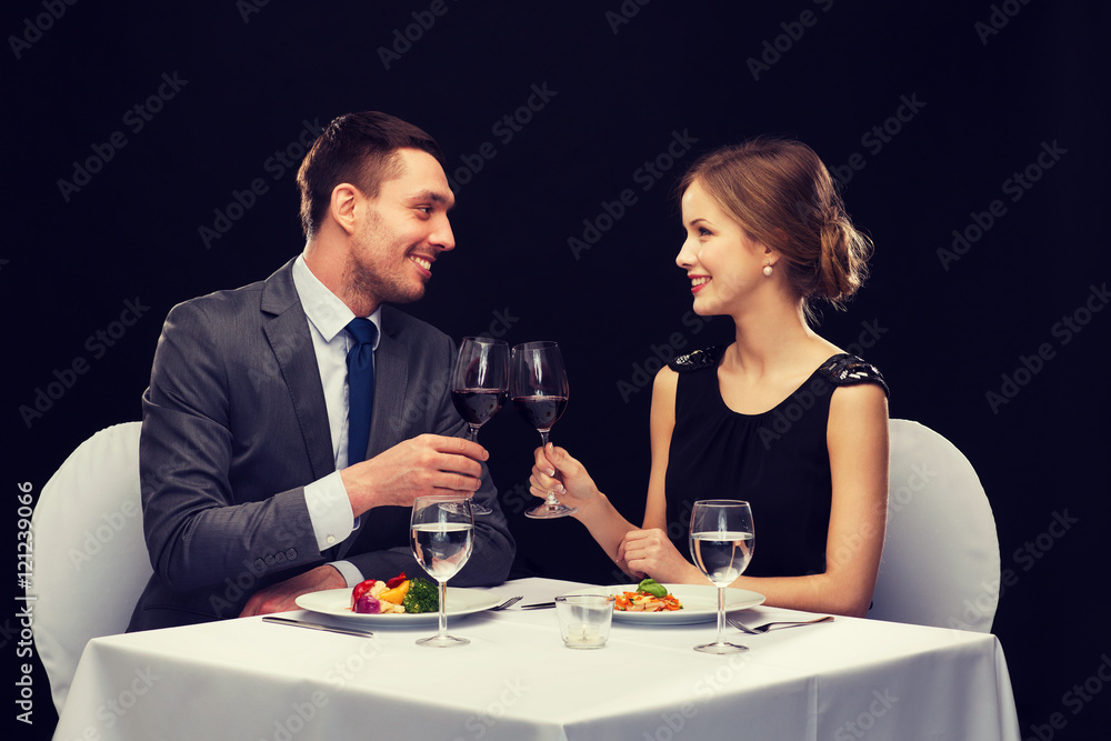 smiling couple eating main course at restaurant smiling couple eating main course at restaurant