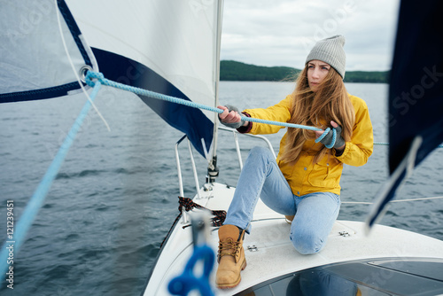 Fotografija Young woman sailing the boat