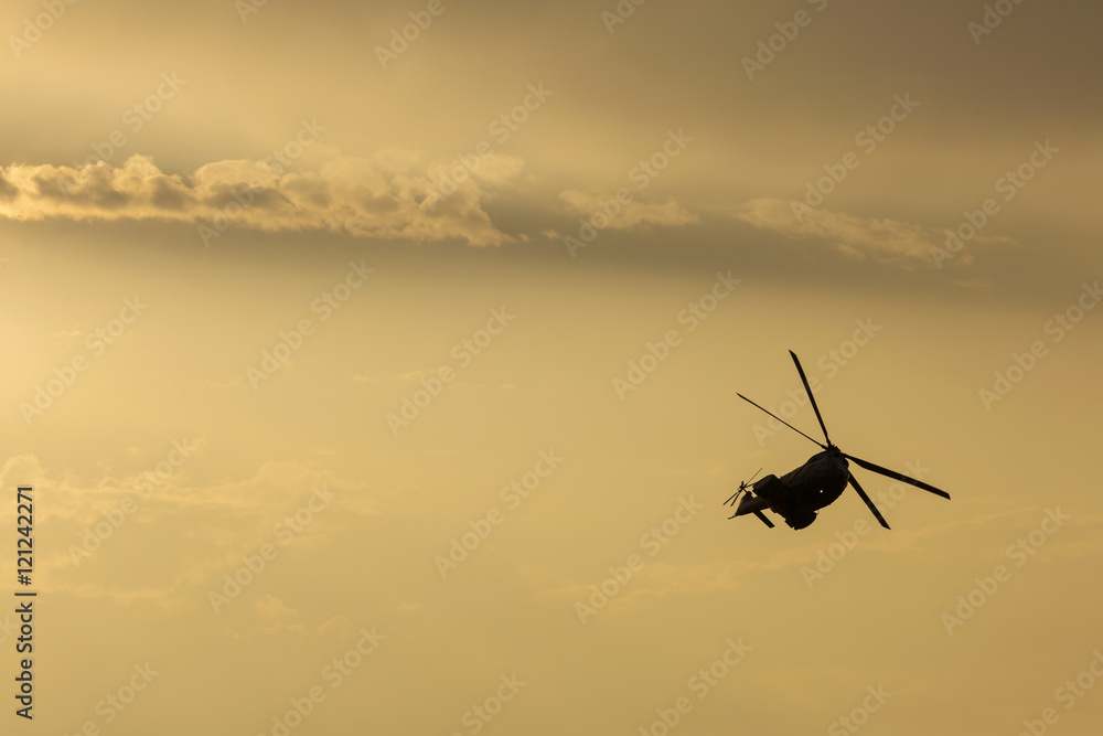 Obraz premium IAR Puma helicopter silhouette flying in the cloudy sky, stunt a