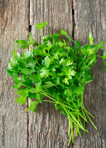 bunch of parsley on wooden surface