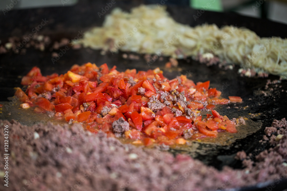 vegetables frying on big wok pan at street market vegetables frying on big wok pan at street market