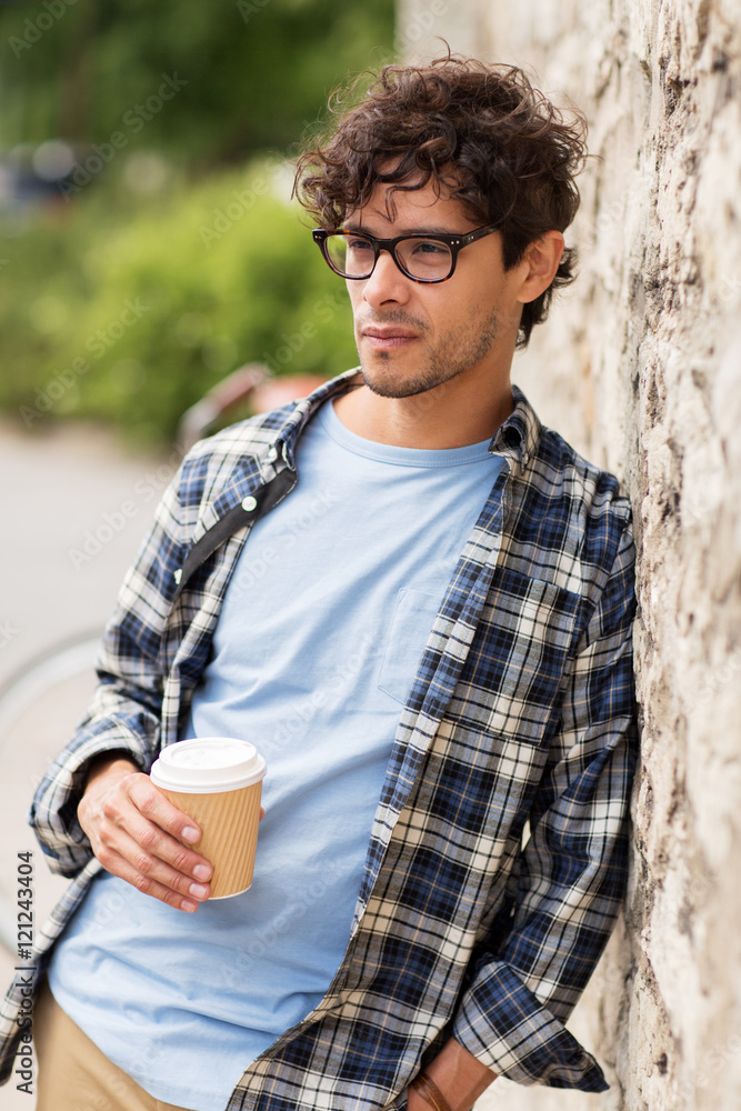 man in eyeglasses drinking coffee over street wall man in eyeglasses drinking coffee over street wall
