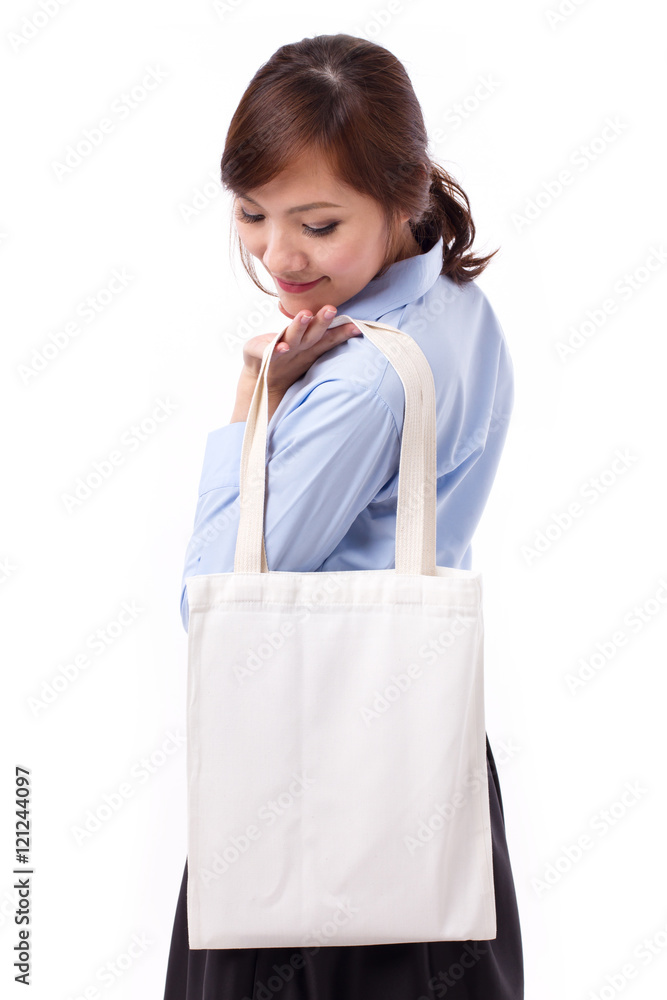 happy, smiling asian woman carrying reusable cotton bag happy, smiling asian woman carrying reusable cotton bag