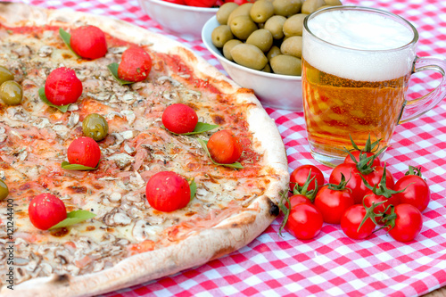 Pizza and beer on table - delicious meal (Mediterranean and internacional food)