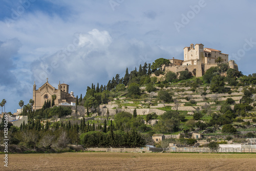 SPAIN, ,MAJORCA, ARTA, 2015-02-02: The churches Transfiguració del Senyor and San Salvador on the hilltop, surrounded by the walls of the fortress, dominate the scenery photo