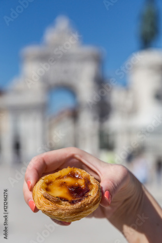 Portuguese dessert Pasteis de nata in women hand