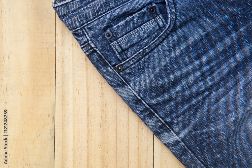 Blue jeans on wooden background Blue jeans on wooden background