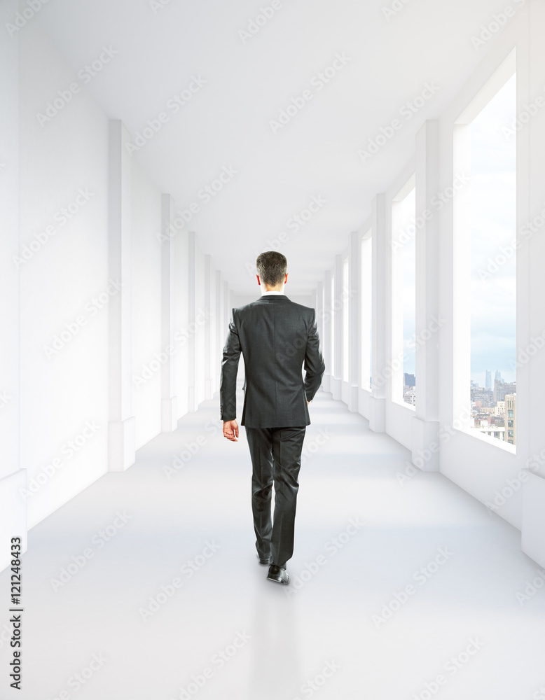Man walking in corridor interior Man walking in corridor interior