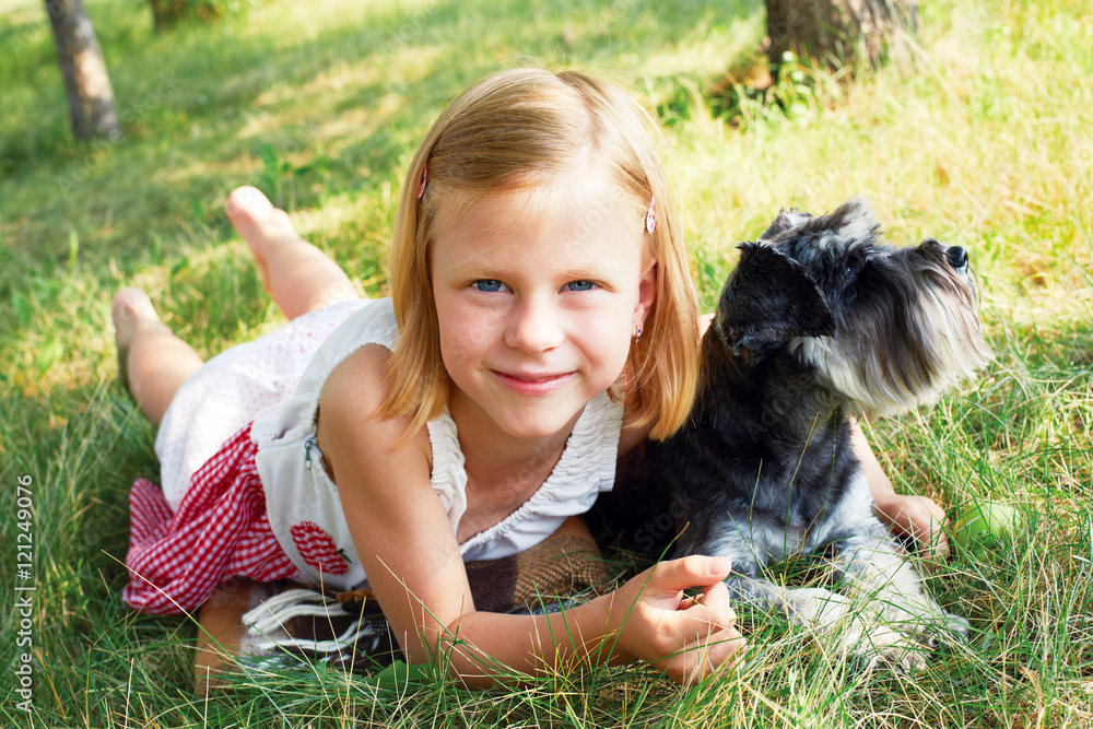 Happy cute little girl hugging her little dog