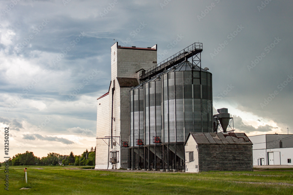 Old Wooden Grain Elevator Against Dramatic Sky Old Wooden Grain Elevator Against Dramatic Sky
