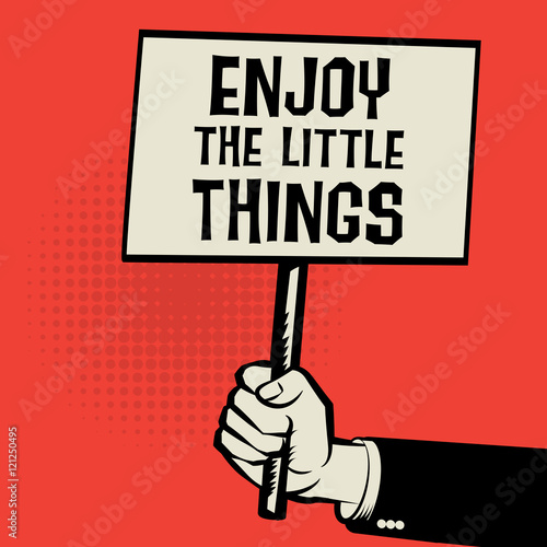Hand holding poster, with text Enjoy the Little things