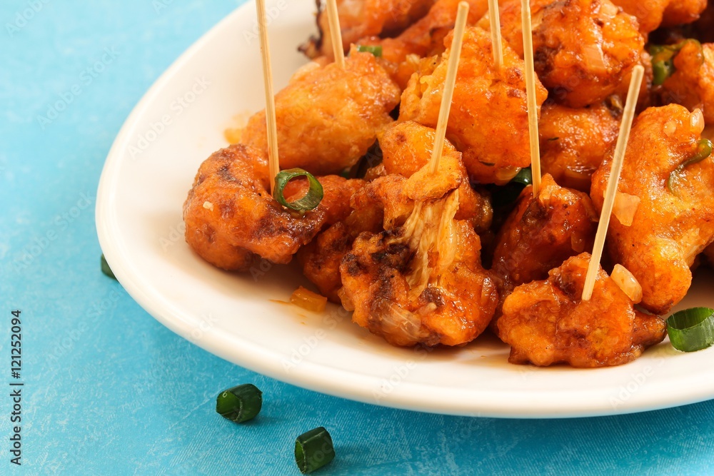 Gobi Manchurian - Indo chinese appetizer using cauliflower florets, selective focus Gobi Manchurian - Indo chinese appetizer using cauliflower florets, selective focus