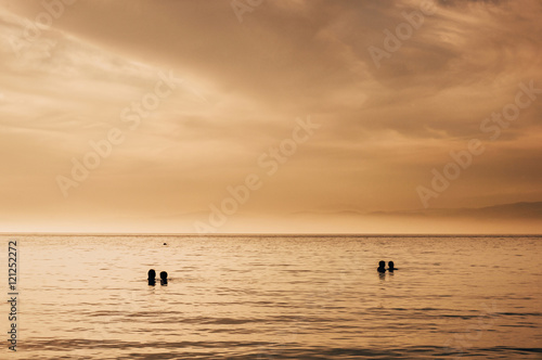 Romantic couples watching sea sunset © Travel_Master