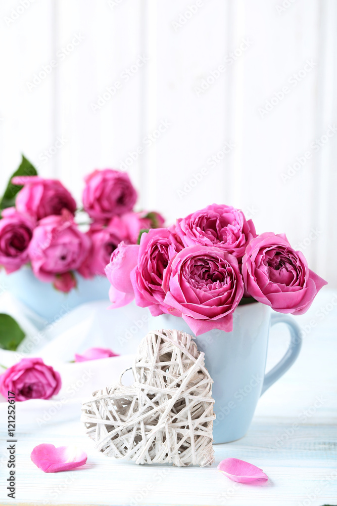 Beautiful pink roses on a white wooden table Beautiful pink roses on a white wooden table