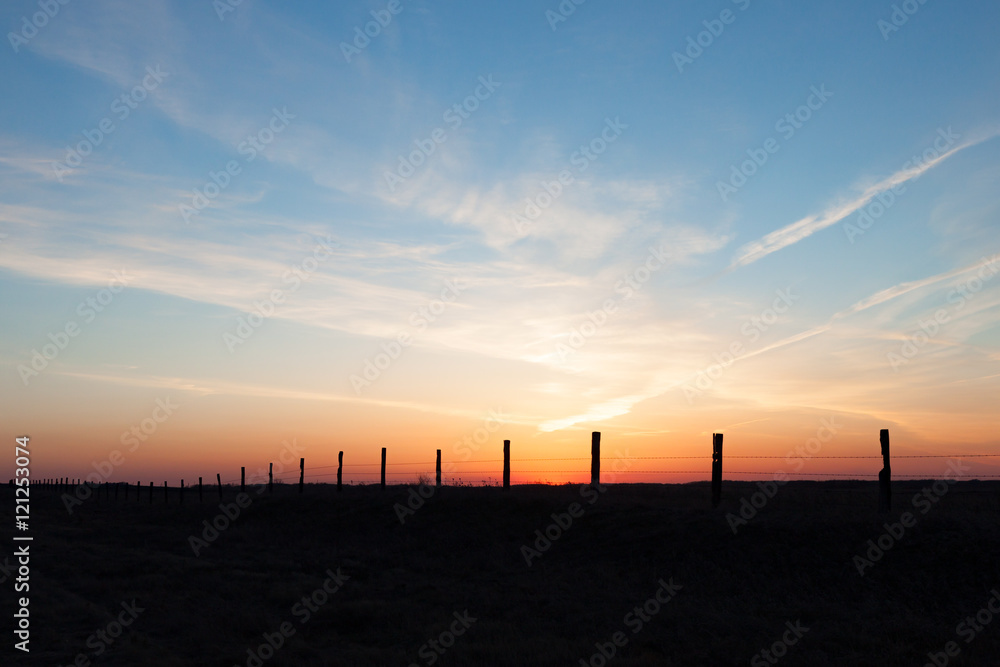 Line of Fence Posts Against Golden Sunset Line of Fence Posts Against Golden Sunset