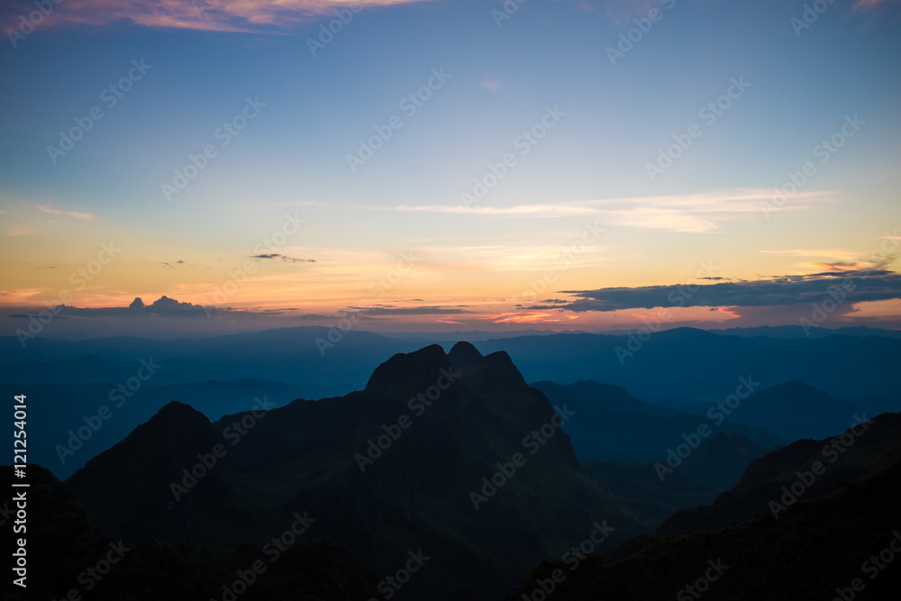 Mountain silhoette of sub alpine at sunrise glowing sky