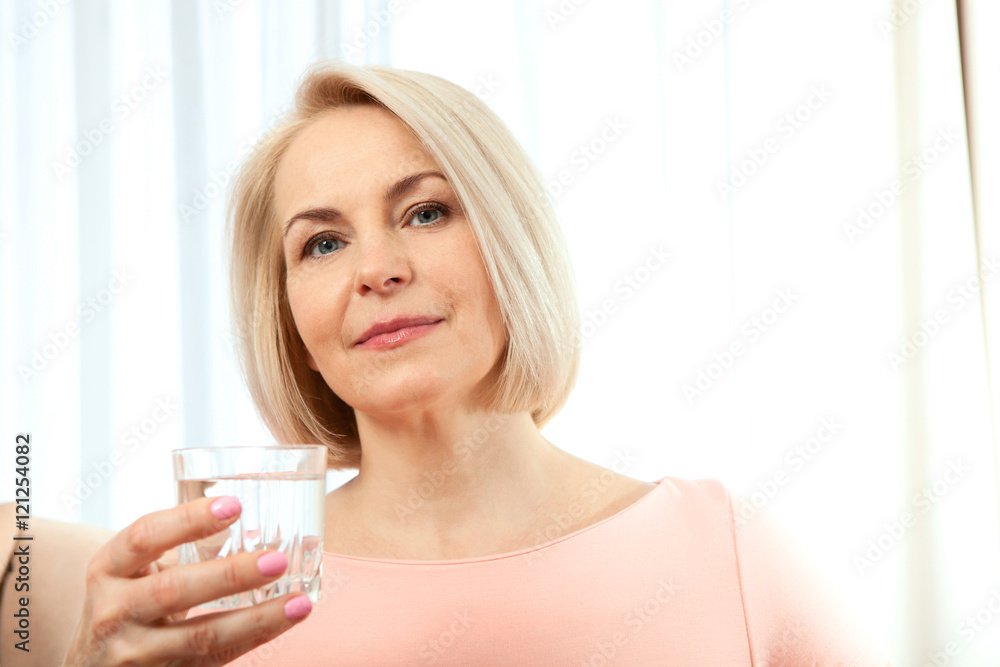 Portrait beautiful middle aged woman drinking water in the morning. Woman's face close up Portrait beautiful middle aged woman drinking water in the morning. Woman's face close up
