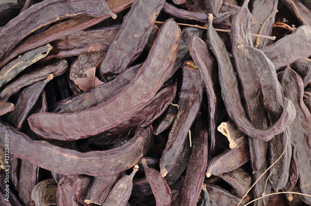 Closeup of carobs in a sack. Agriculture and goods retail