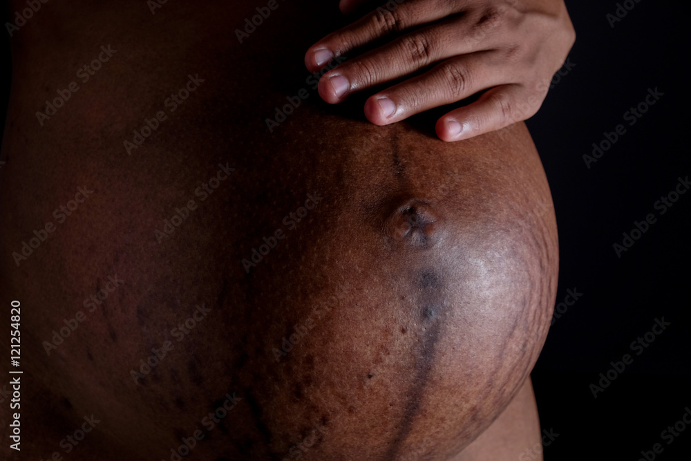 Naklejka premium Belly of a pregnant woman