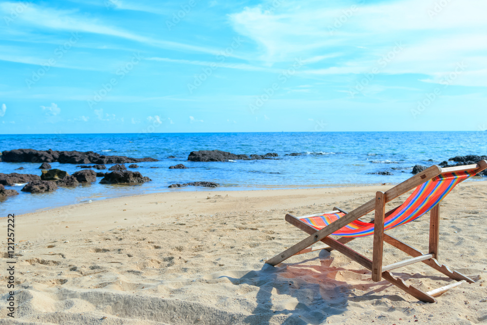 An empty wooden beach chair at the beach
