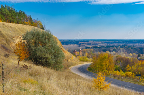 Autumnal landscape with road leading to in Chervlene village, Sumy Oblast, Ukraine. photo