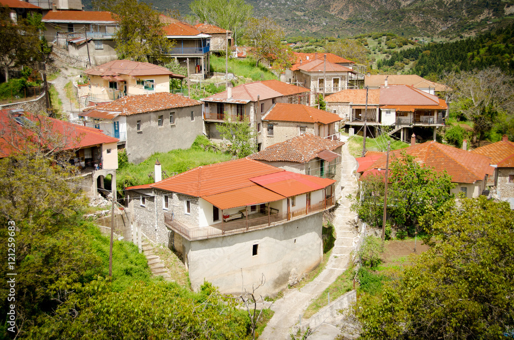 House and cemetery on the top of the hill, Baltessiniko village. Arcadia, Peloponnese,Greece House and cemetery on the top of the hill, Baltessiniko village. Arcadia, Peloponnese,Greece