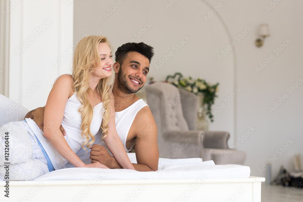 Young Couple Lying In Bed Looking At Each Other, Happy Smile Hispanic Man And Woman Young Couple Lying In Bed Looking At Each Other, Happy Smile Hispanic Man And Woman