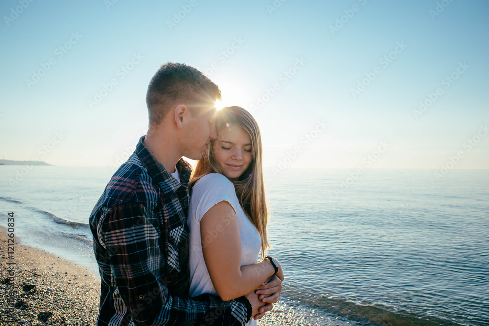 young loving couple walking on beach