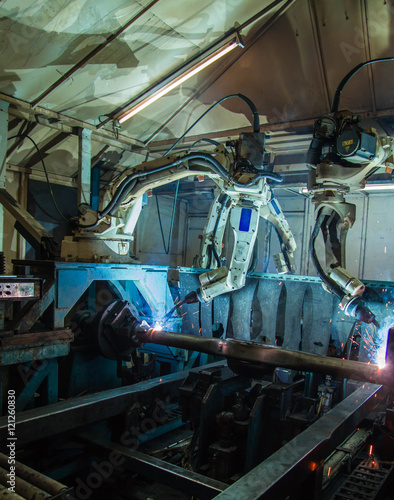 Team Robot welding movement Industrial automotive part in factory