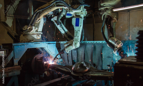 Team Robot welding movement Industrial automotive part in factory