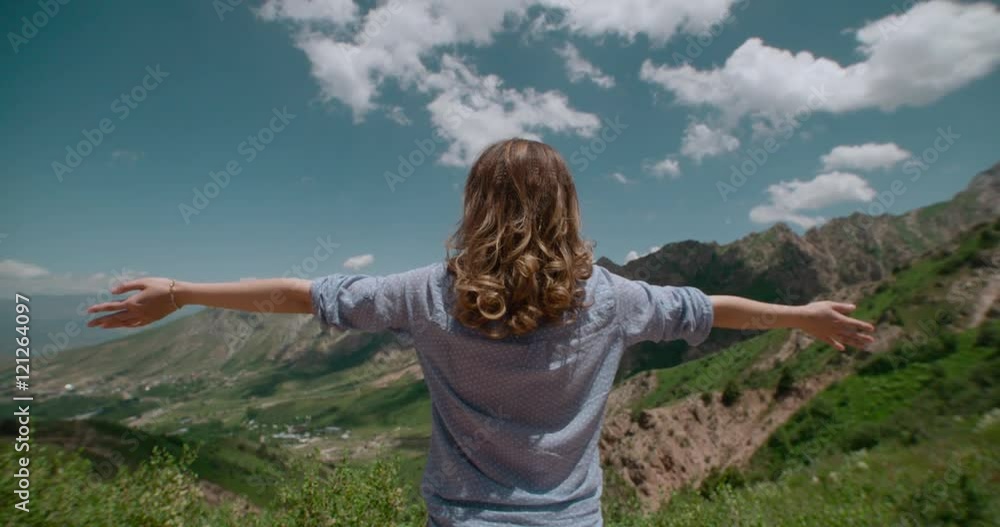 Successful woman raising hands on the top of mountain Successful woman raising hands on the top of mountain