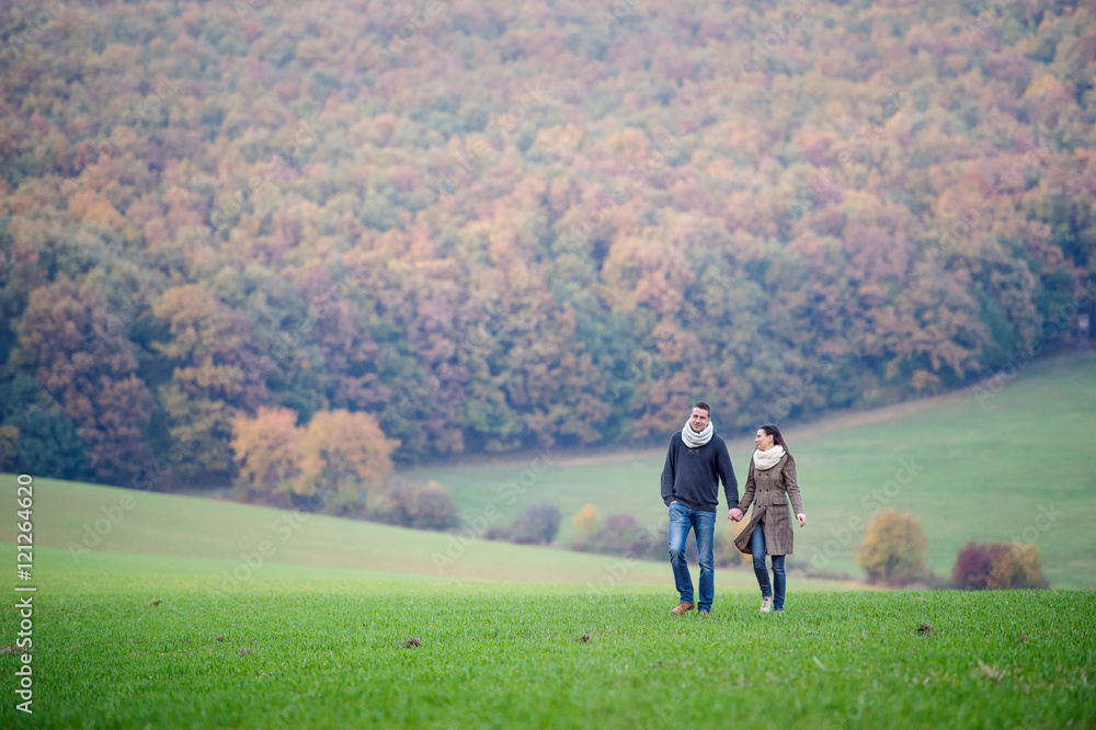 Beautiful young couple on a walk. Colorful autumn nature. Beautiful young couple on a walk. Colorful autumn nature.