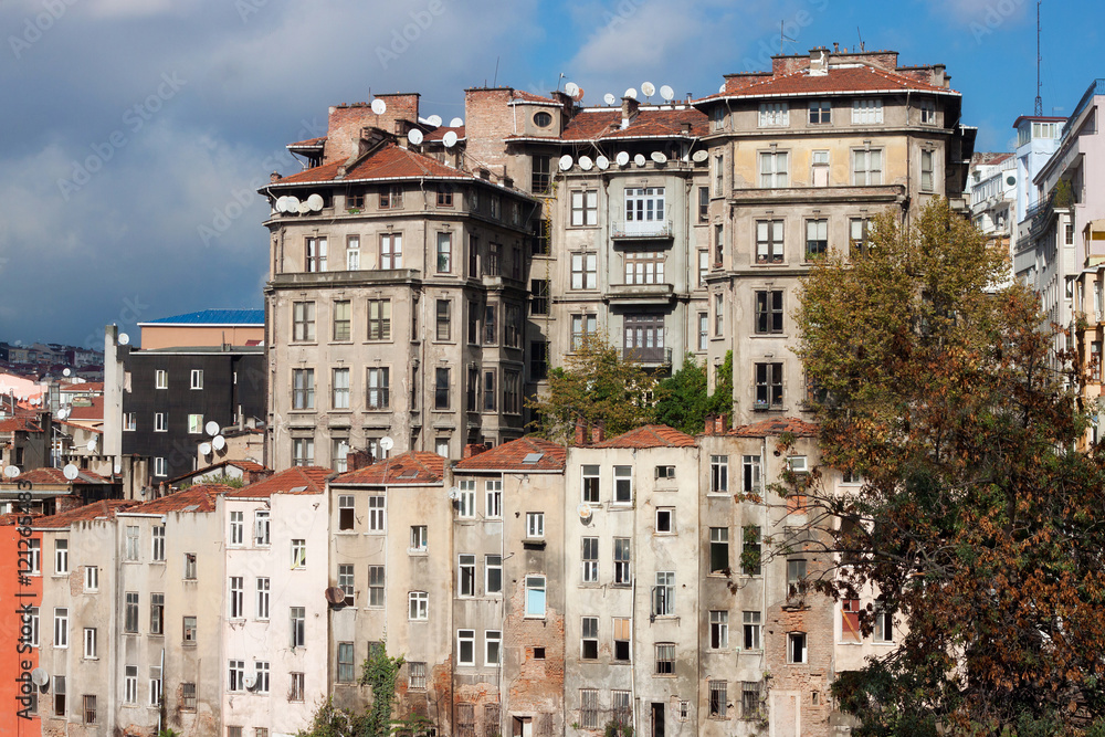 Fototapeta premium View of old houses and tiled roofs of Istanbul in the Beyoglu district. Next to the famous Taksim Square.