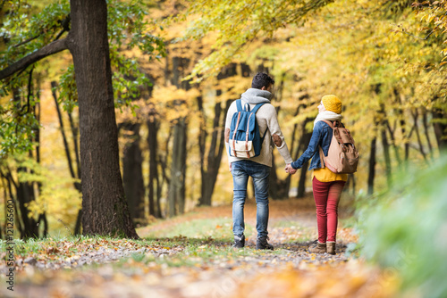 Beautiful couple on a walk in autumn forest