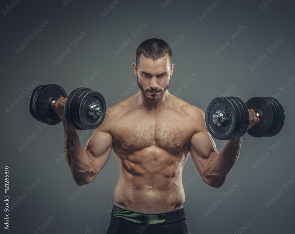 Male doing biceps workouts with dumbbells.