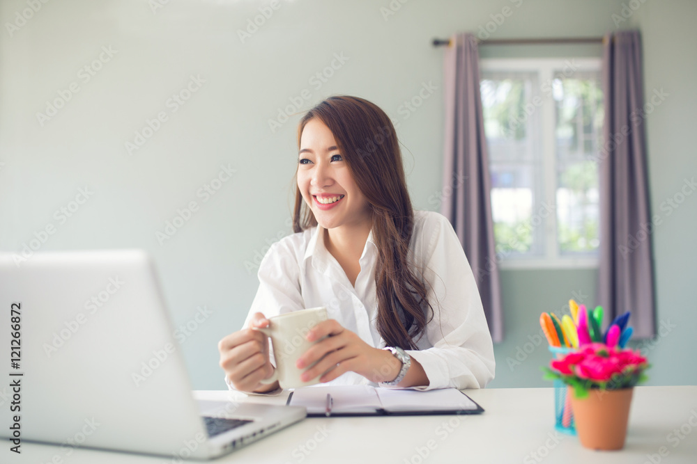 Smiling female use laptop hand holding a cup Smiling female use laptop hand holding a cup