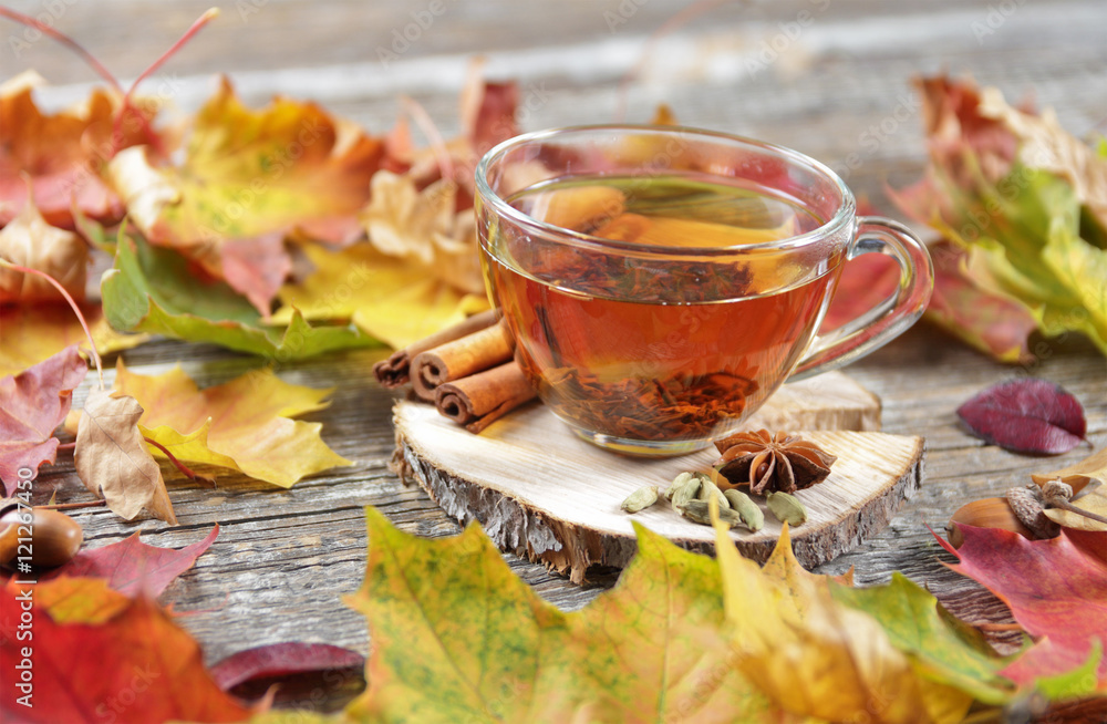 cup of tea on the wooden background with autumn leaves cup of tea on the wooden background with autumn leaves