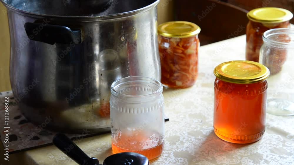 Housewife pours homemade jam in jar Housewife pours homemade jam in jar