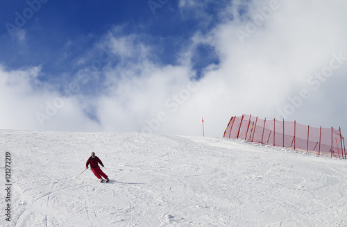 Skier on ski slope at nice sun day photo