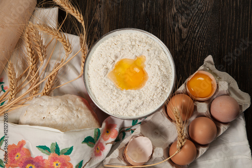 Wallpaper Mural ingredients for homemade bread on vintage wooden background and towel with embroidered ears of wheat, milk, eggs, flour, dough, bread Torontodigital.ca