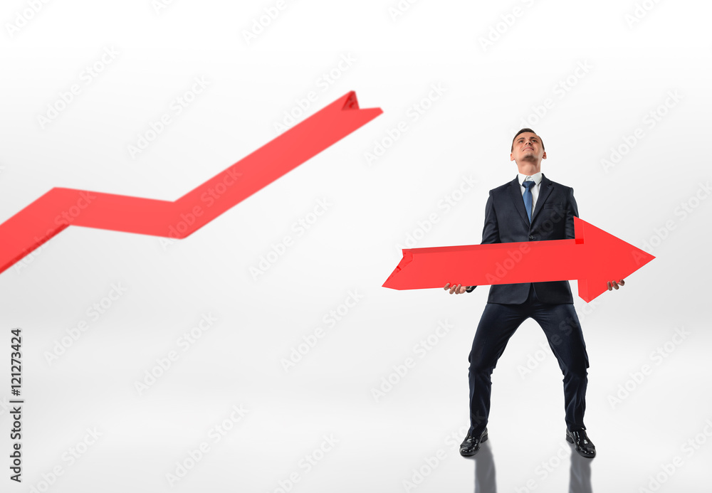 Businessman holding big broken arrow with both hands isolated on white background Businessman holding big broken arrow with both hands isolated on white background