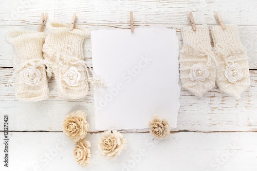 New Born or baptism Greeting Card. Blank with baby girl shoes and gloves on white wooden background