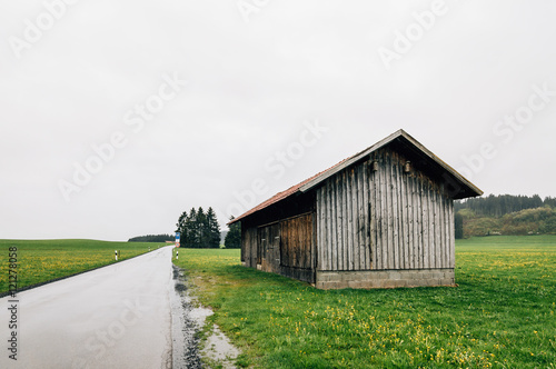 Lonely cottage in the fields a cloudy day. Horizontal composition, space for copy