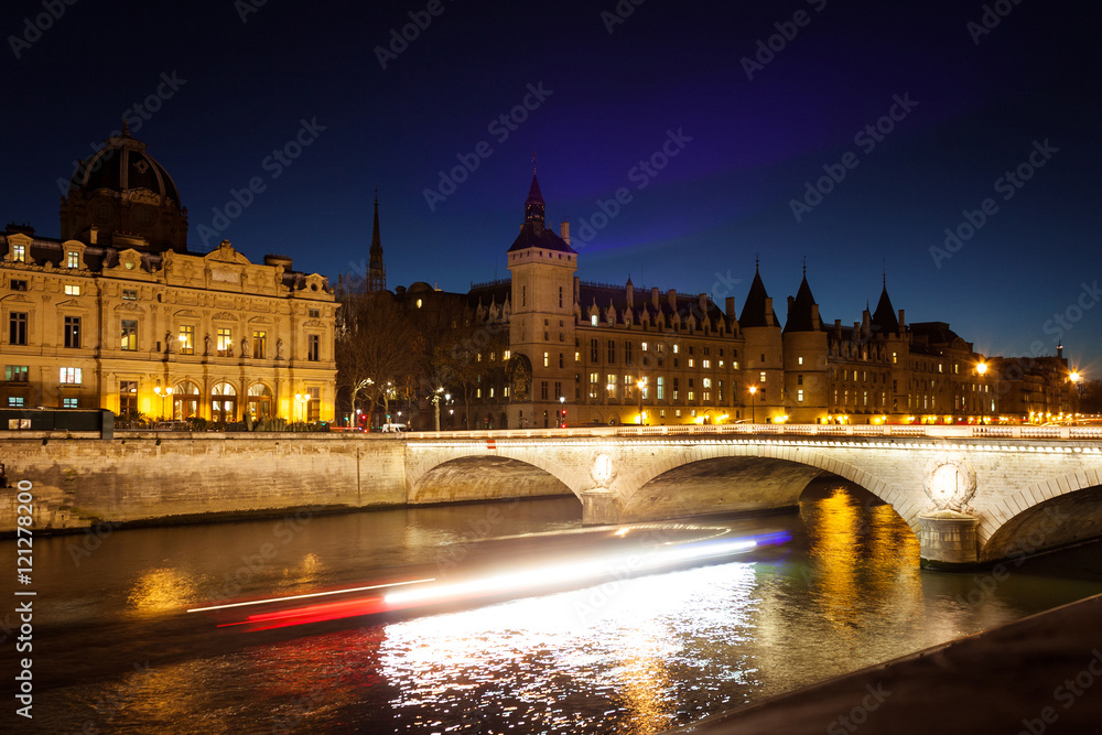 View from the embankment to the Conciergerie et le Pont de Change at night. The 
