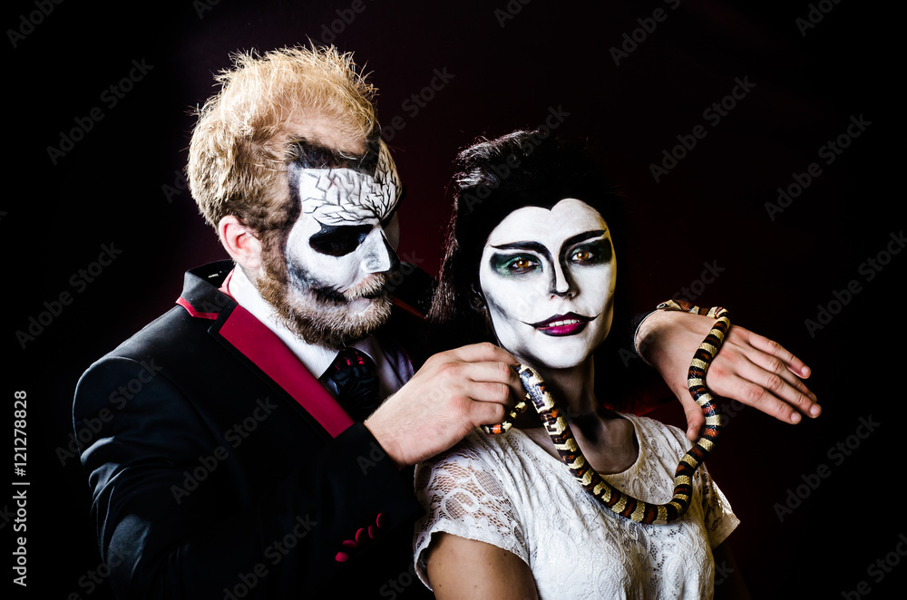 Dead face boy and girl with beautiful snake Dead face boy and girl with beautiful snake
