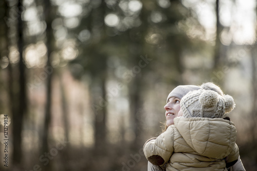 Photos Young mother carrying her young child