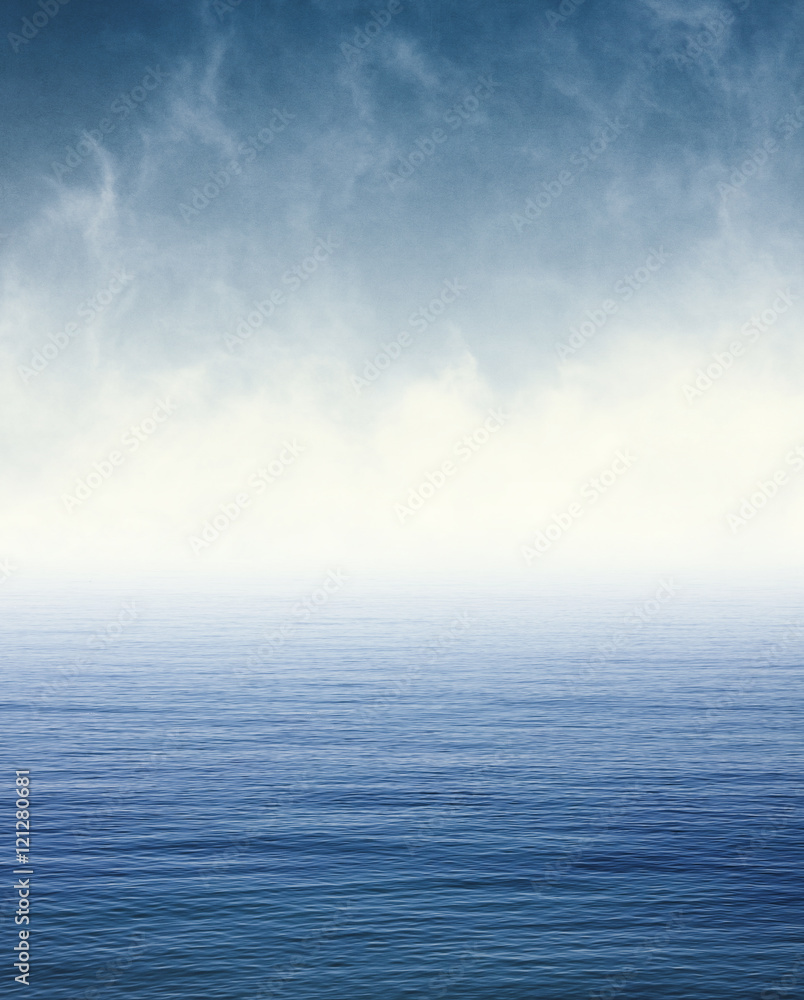 Naklejka premium Fog on Blue Ocean. Fog and clouds hovering over the Pacific ocean. Image displays a pleasing paper grain and texture at 100%.