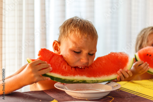 Children eat watermelon photo