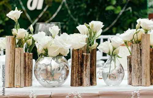 Beautiful decor at the wedding. The flowers on the background of the boards. Close-Up